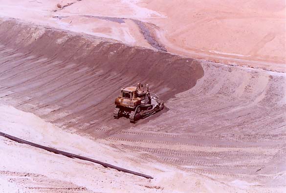 Compaction of coarse materials on downstream side of Spoil Dam at Quebrada Honda, Moquegua, Peru.