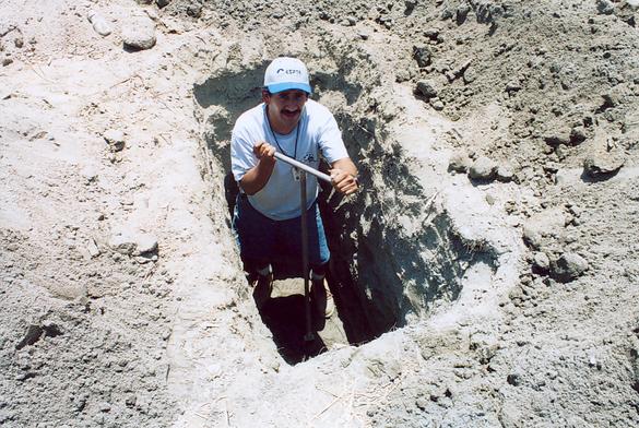 Worker augering borehole at RP-5